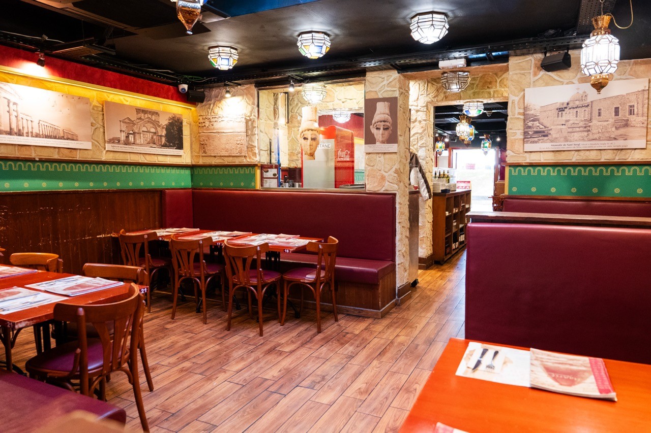 Restaurant exterior with black facade and welcoming atmosphere.