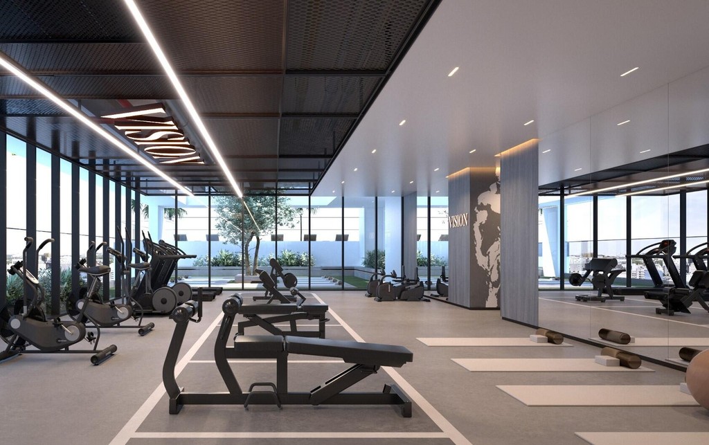 A gym room featuring various exercise equipment and large mirrors, branded as Vista by Vision.