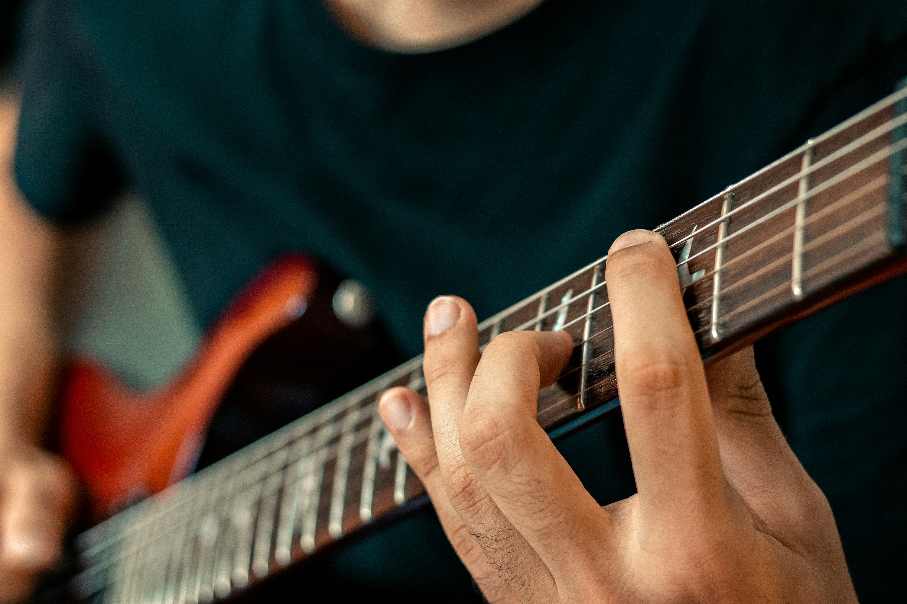Man fretting a guitar
