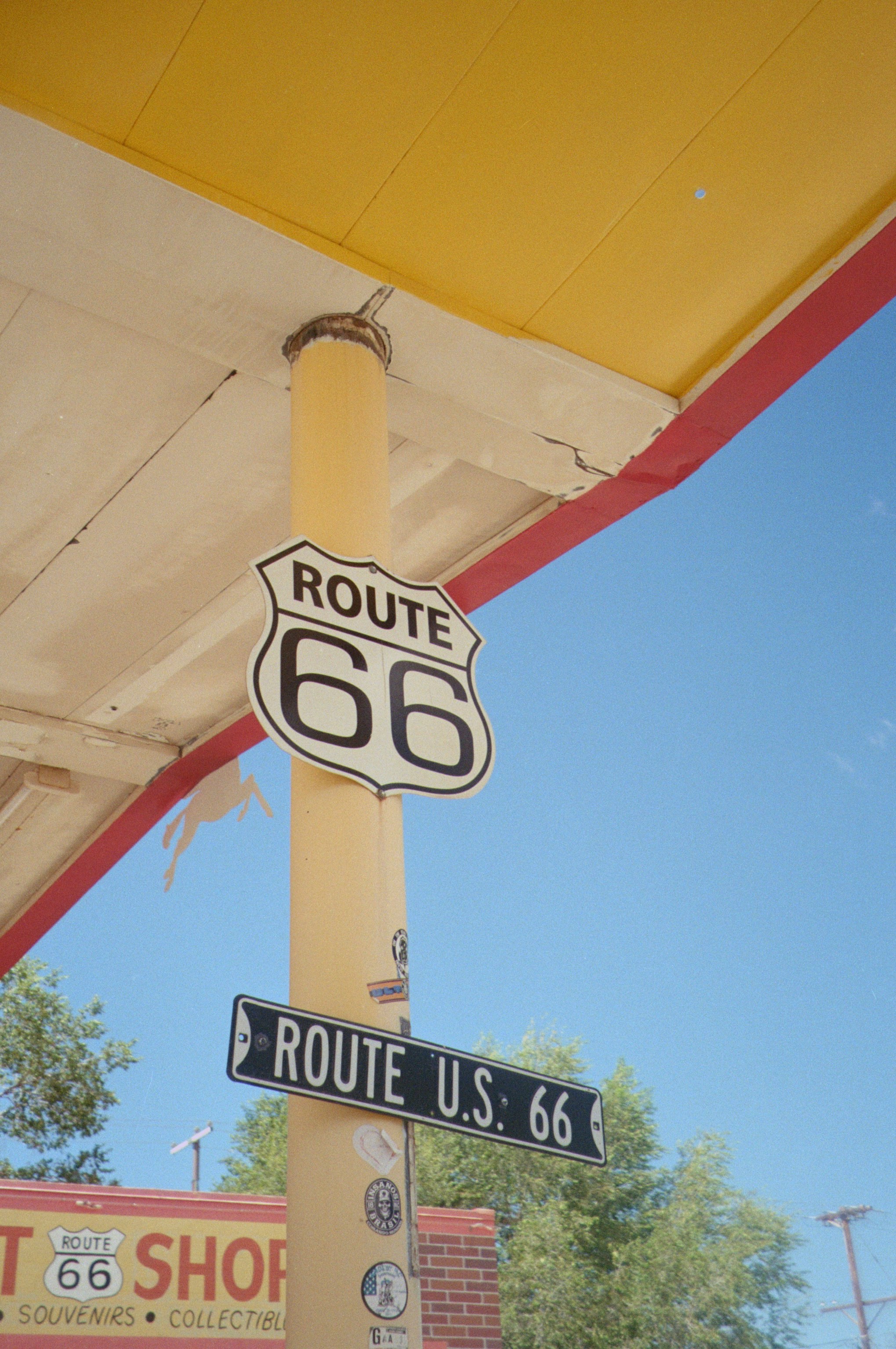 Route 66 sign on a yellow pole