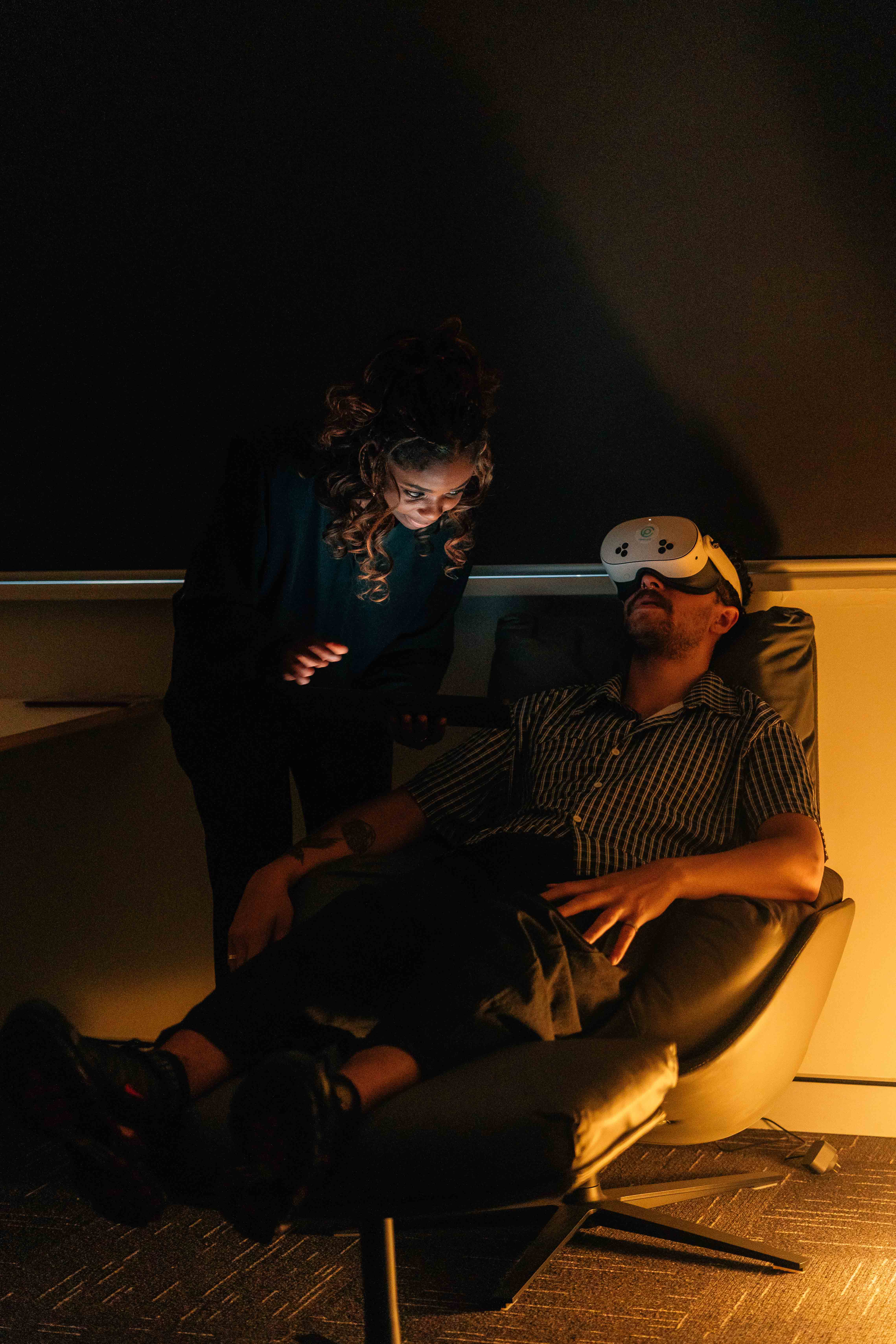 woman in black jacket sitting beside woman in white blazer
