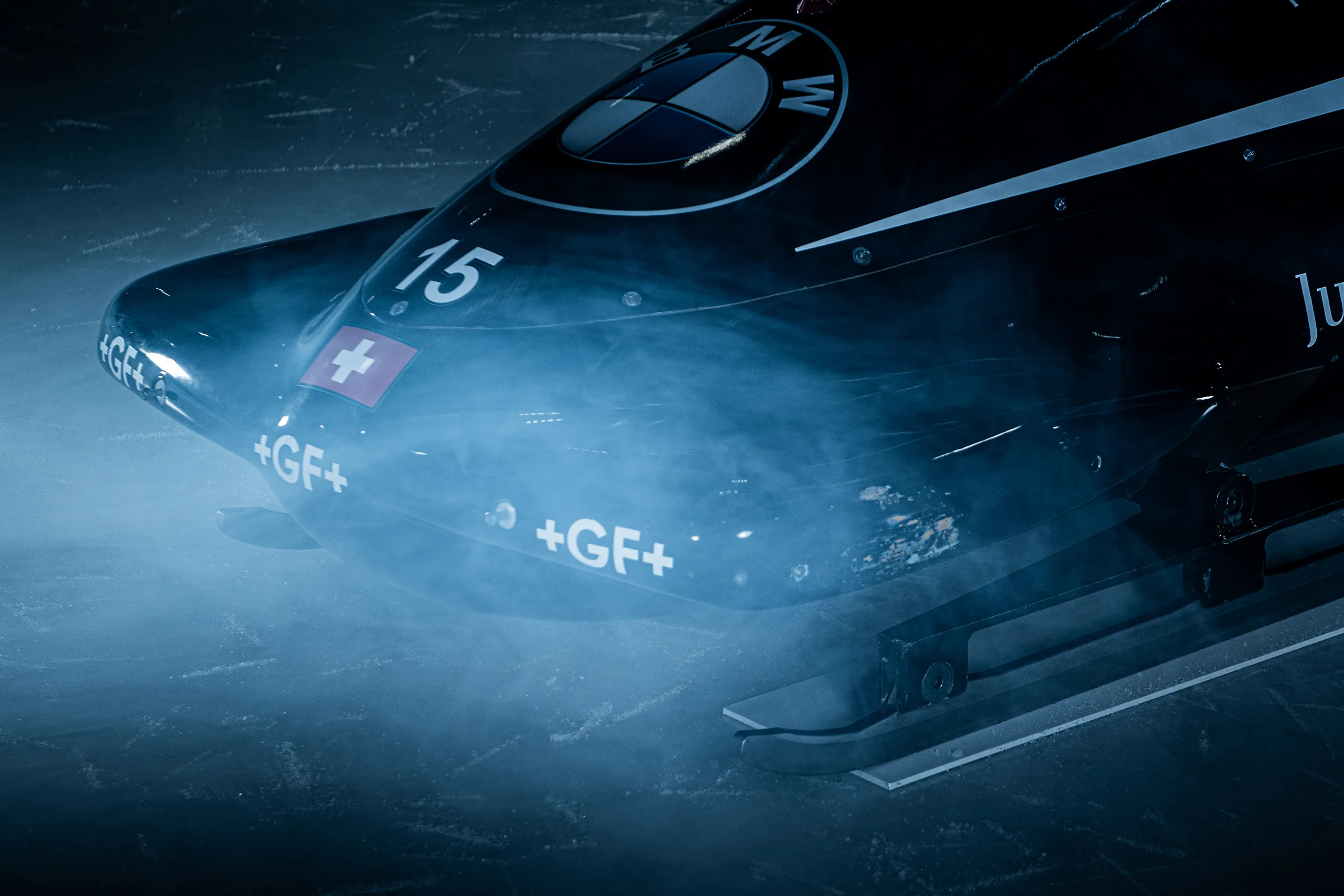 Close-up of the Bobteam Vogt bobsled in the fog on the ice at the rink in Zug.
