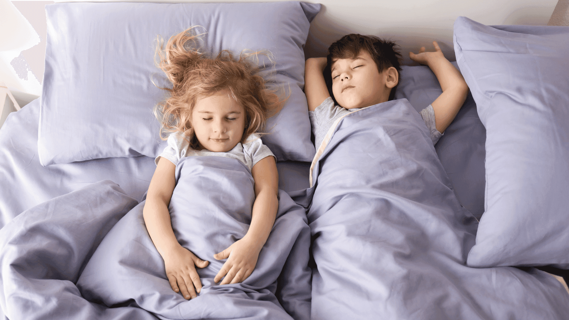 Two children fast asleep, looking calm, relaxed, and peaceful.