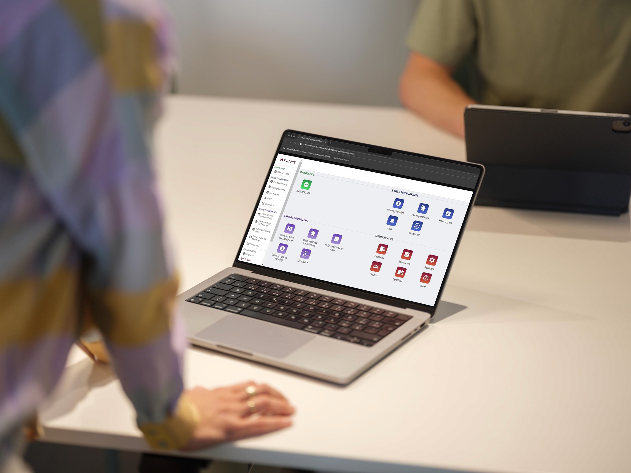 A laptop displaying the K-Analytics interface during a meeting, showcasing Kowee’s dynamic pricing solution implementation process.