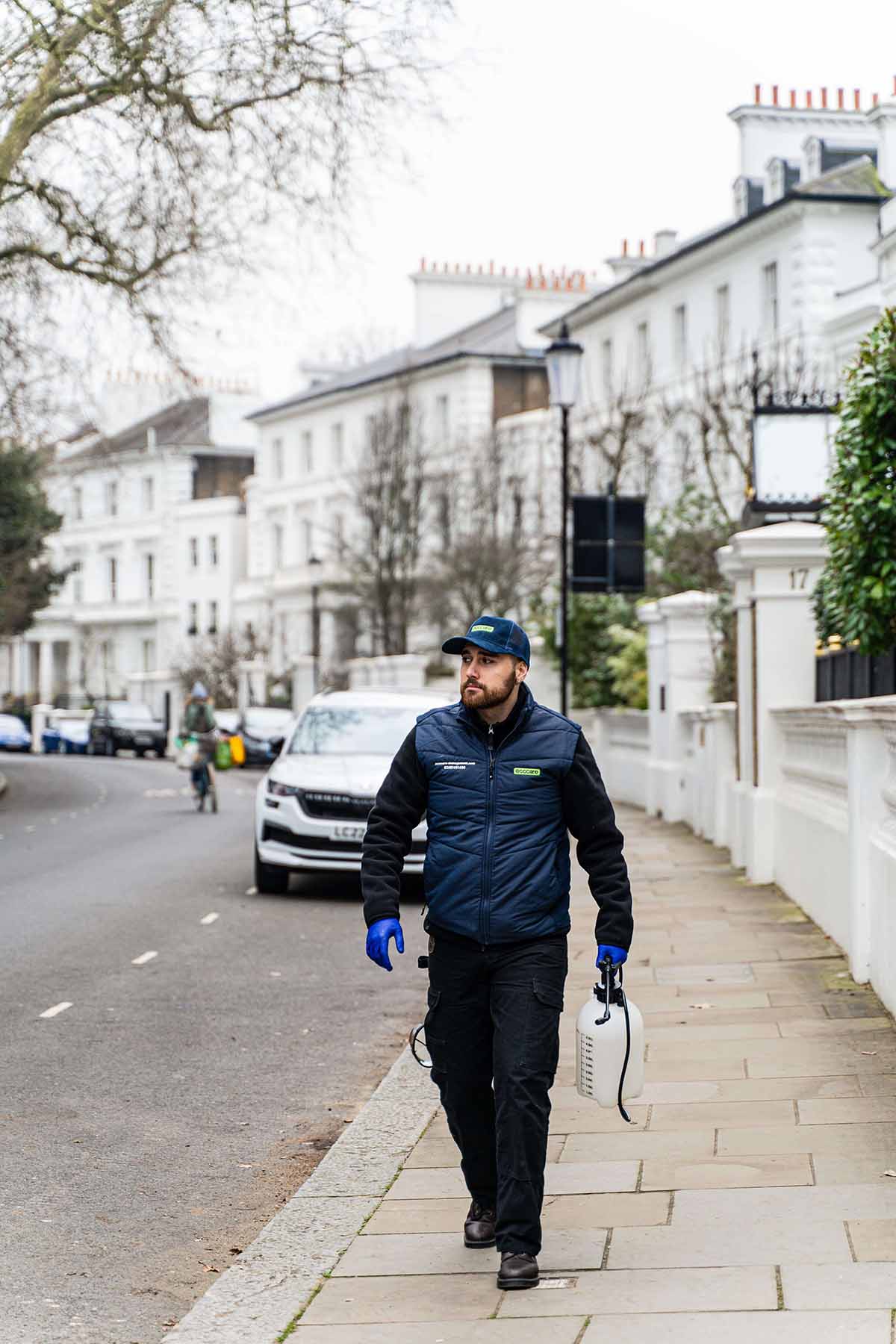 Pest control technician in uniform at London property - Local commercial pest services in residential neighborhoods
