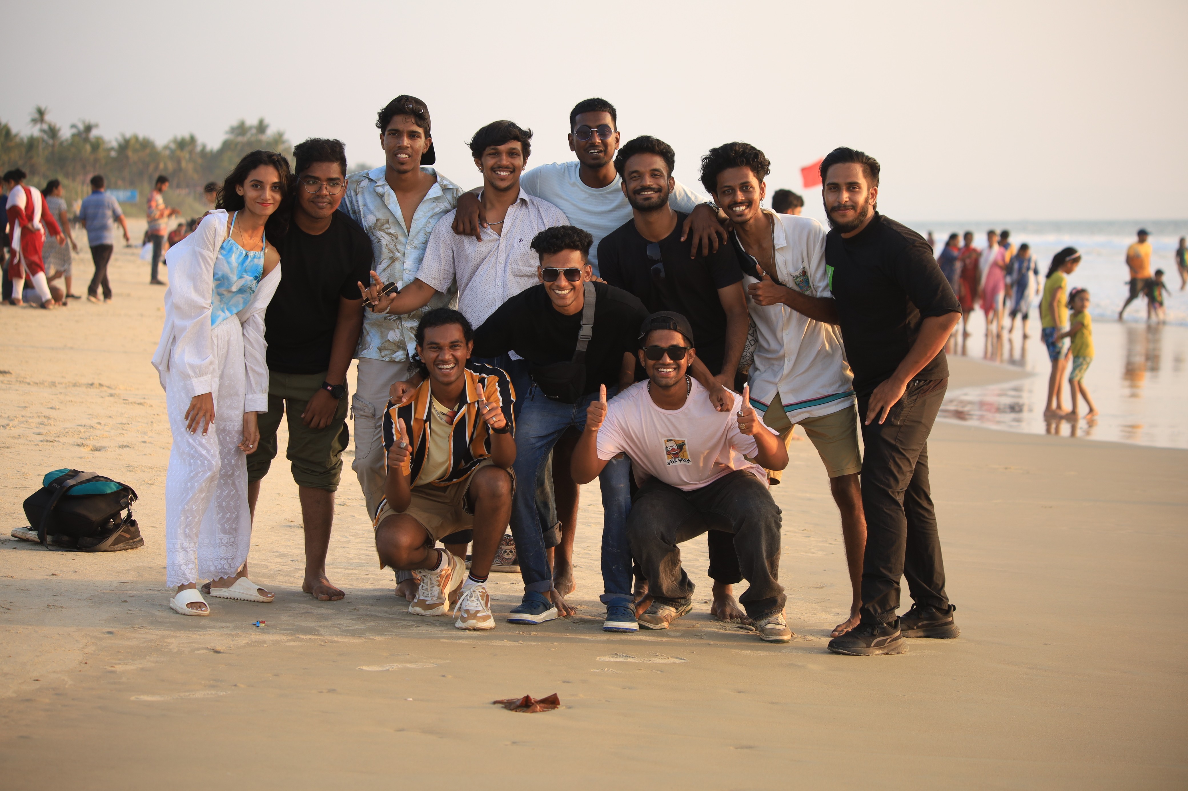 A group of friends posing together on the beach