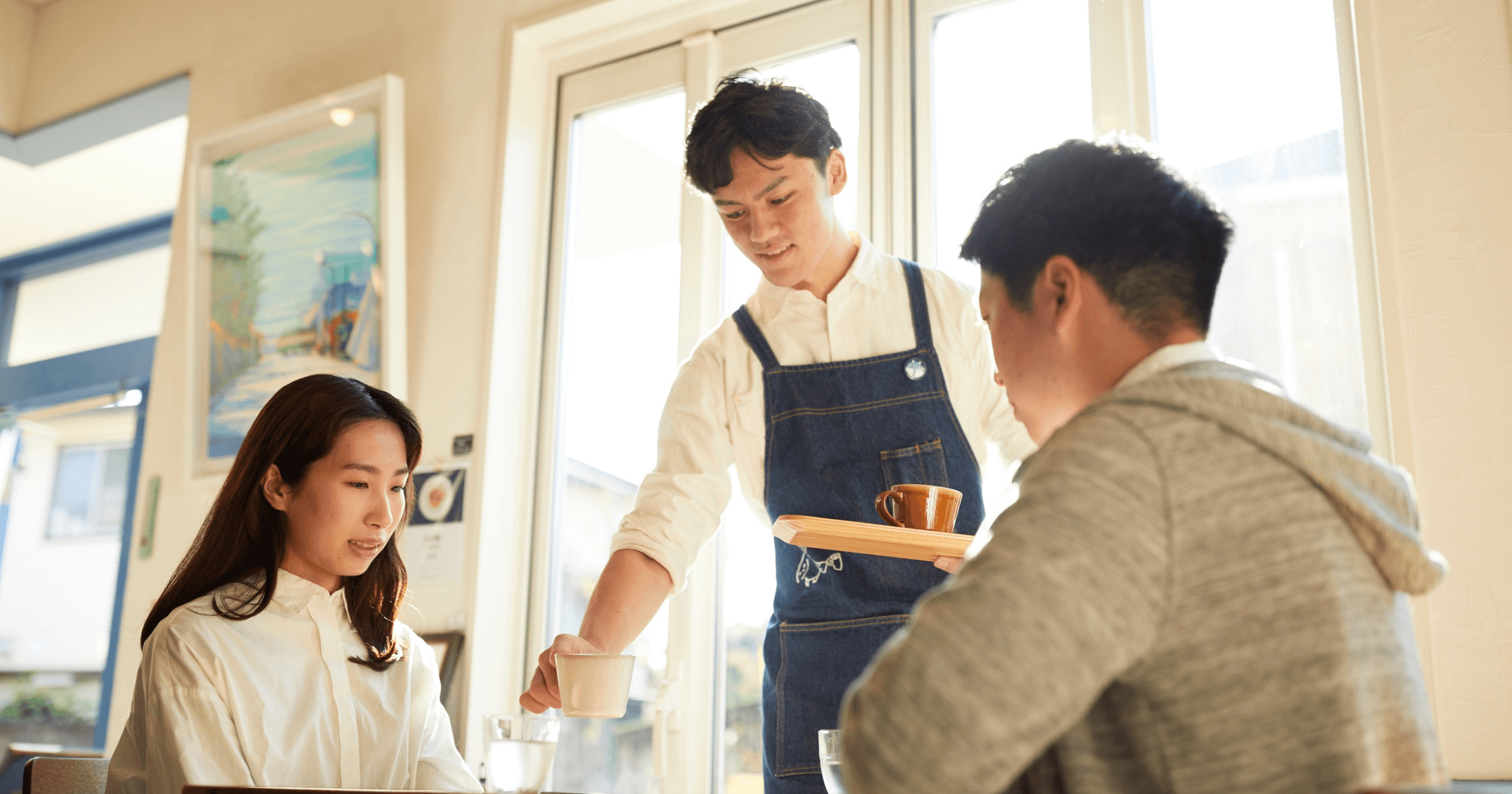 An F&B staff serving food to customers at a restaurant