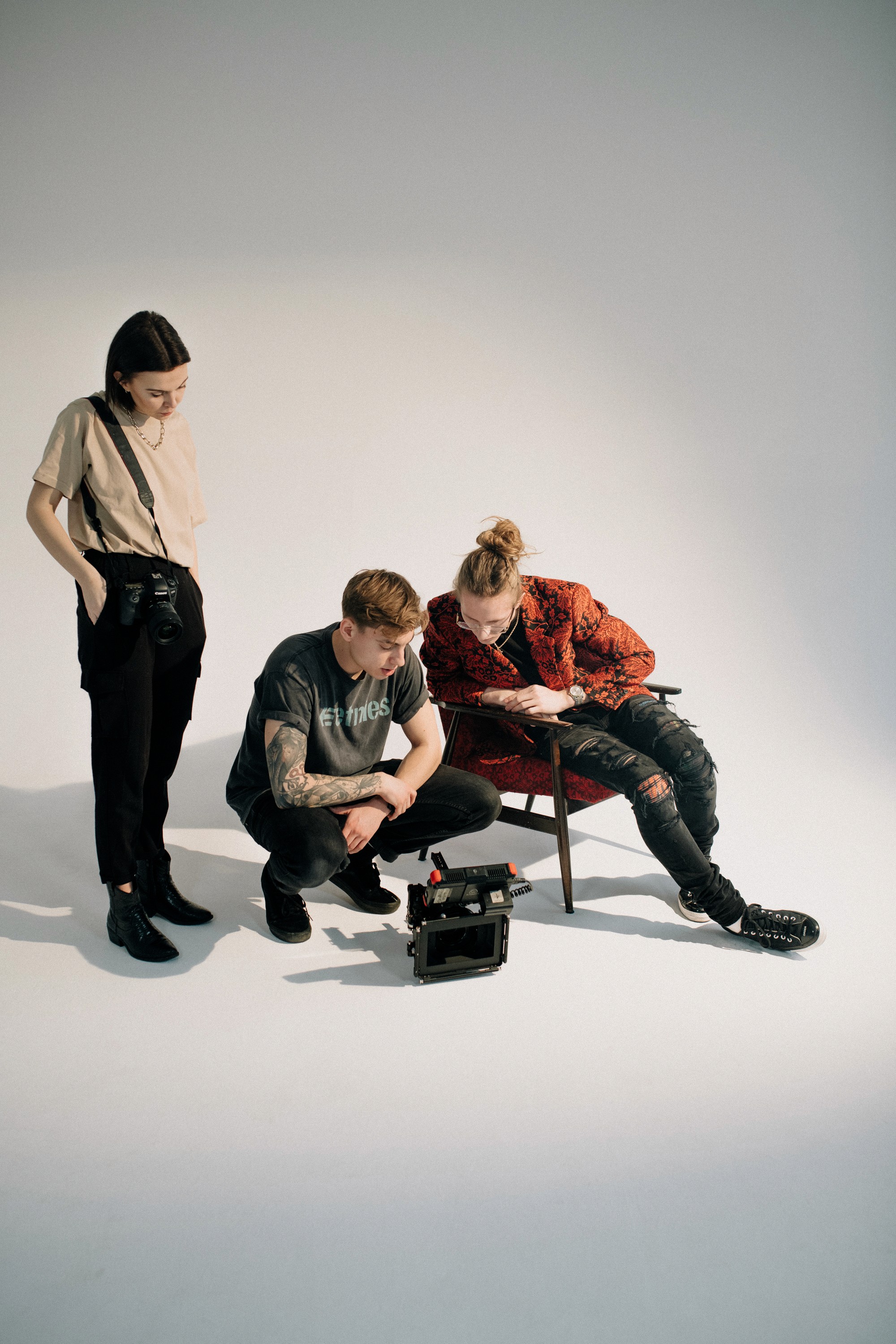 A close-up of a pink cocktail in a martini glass, set against a nighttime background with soft, blurred colors.