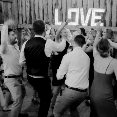 Friends dancing and having fun at a wedding in Newmarket, Ontario, enjoying the lively atmosphere and celebrating the special day together.