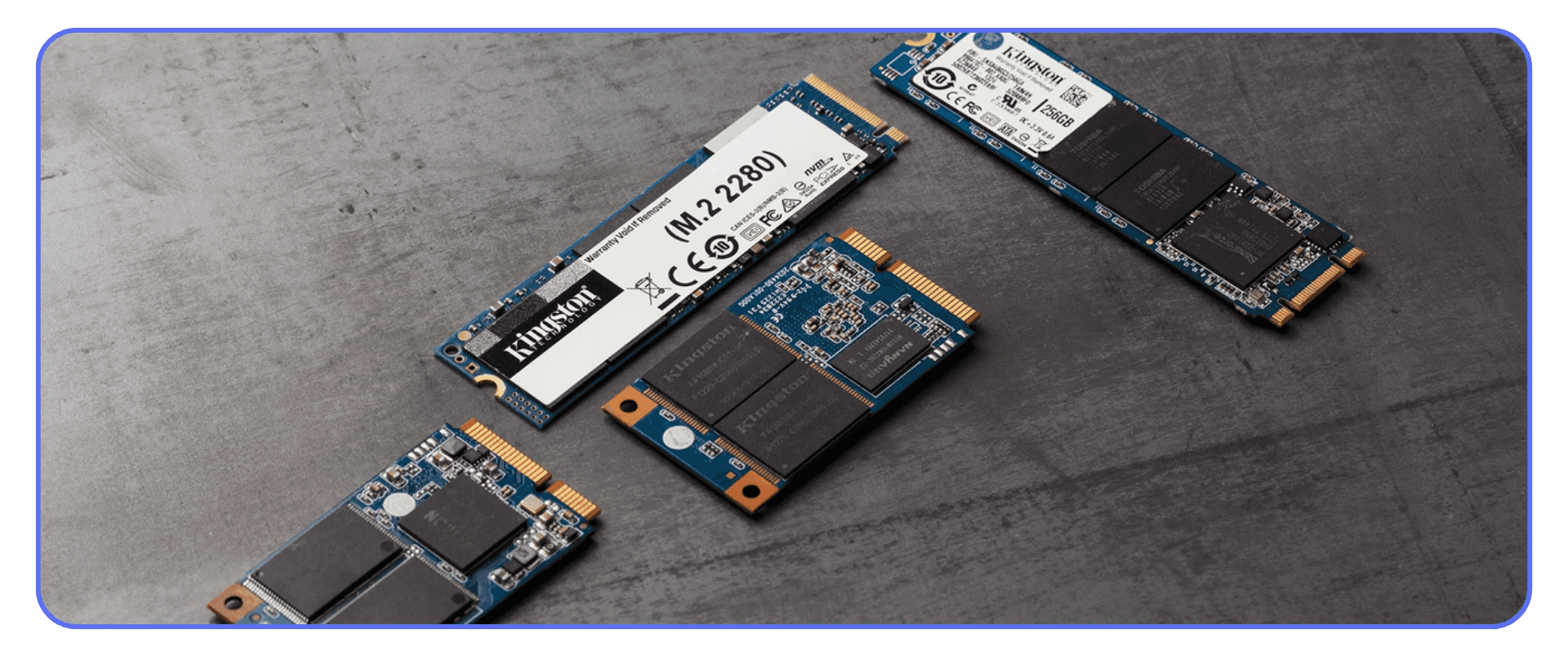 Multiple M.2 SSD drives on a gray surface, representing fast storage crucial for smooth AI rendering and video upscaling workflows.