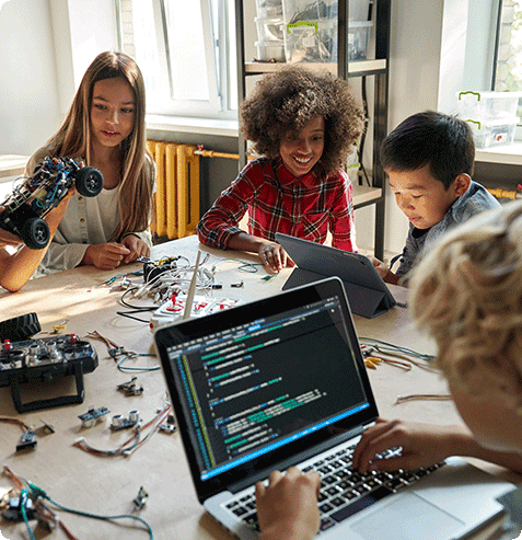 students learning coding and AI literacy through hands-on robotics and technology activities in the classroom