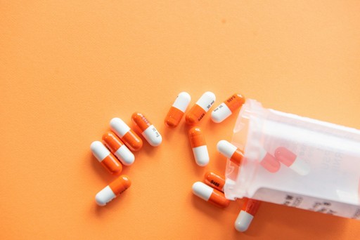 orange and white medication pill illustrating prescriptions