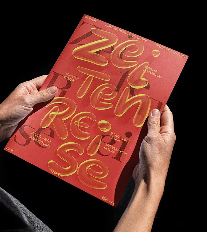 A red brochure with solid black and translucid yellow texts that overlap