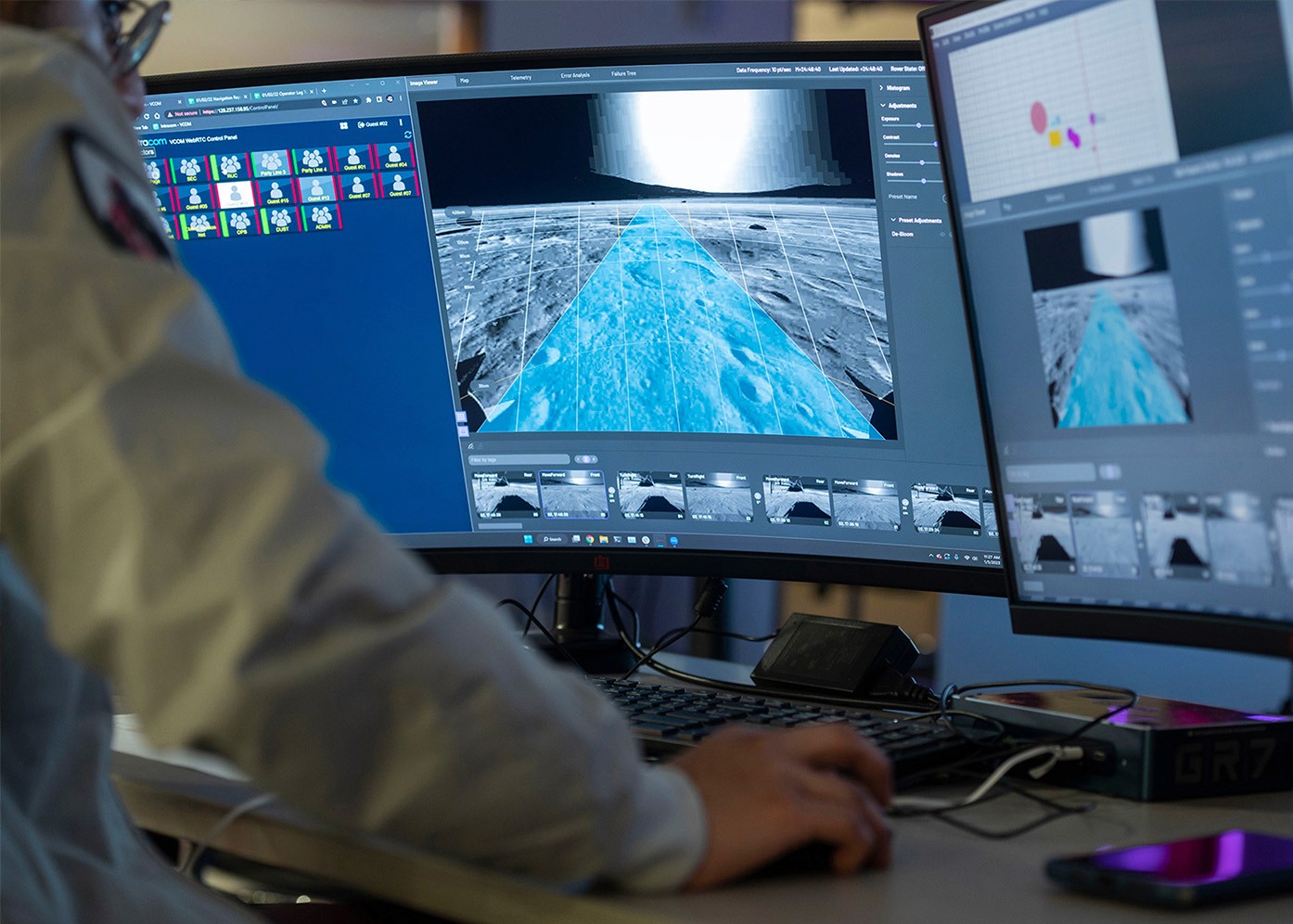 Two monitors showing VCOM WebRTC Control Panel and the moon's surface