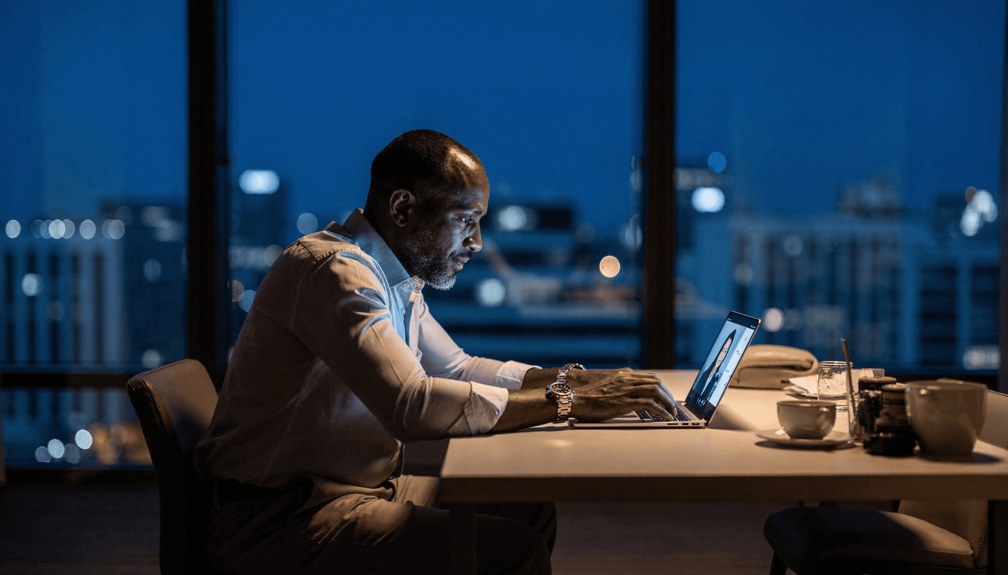Busienss man in a hotel room desk with some minimalistic art on the wall