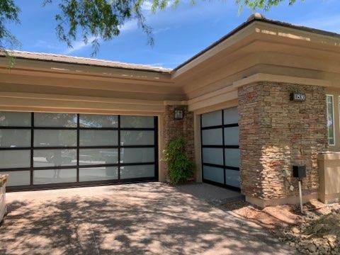 Driveway view of garage doors with glass paned panels