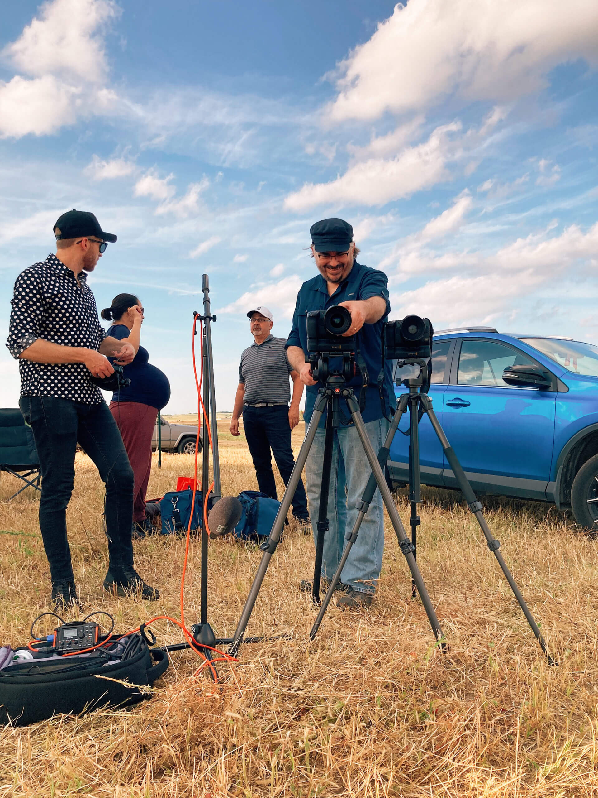 People standing around camera outside