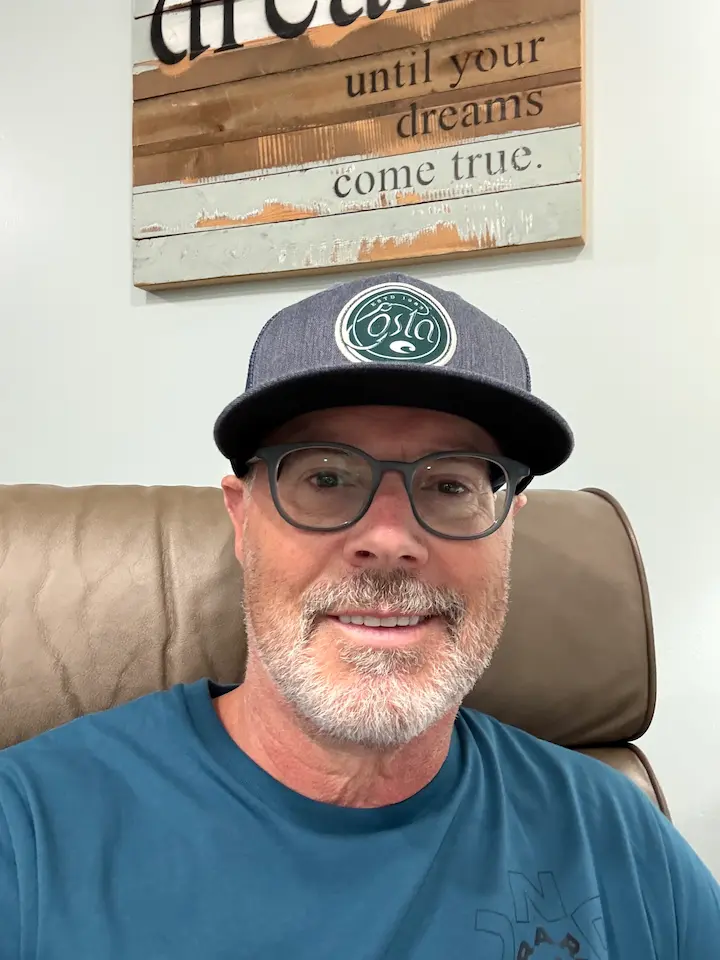 Relaxing in a recliner wearing a ball cap