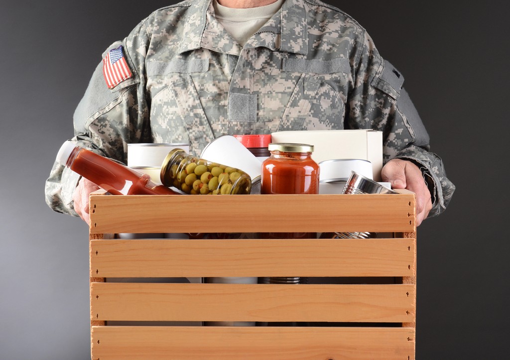 Soldier carrying canned foods