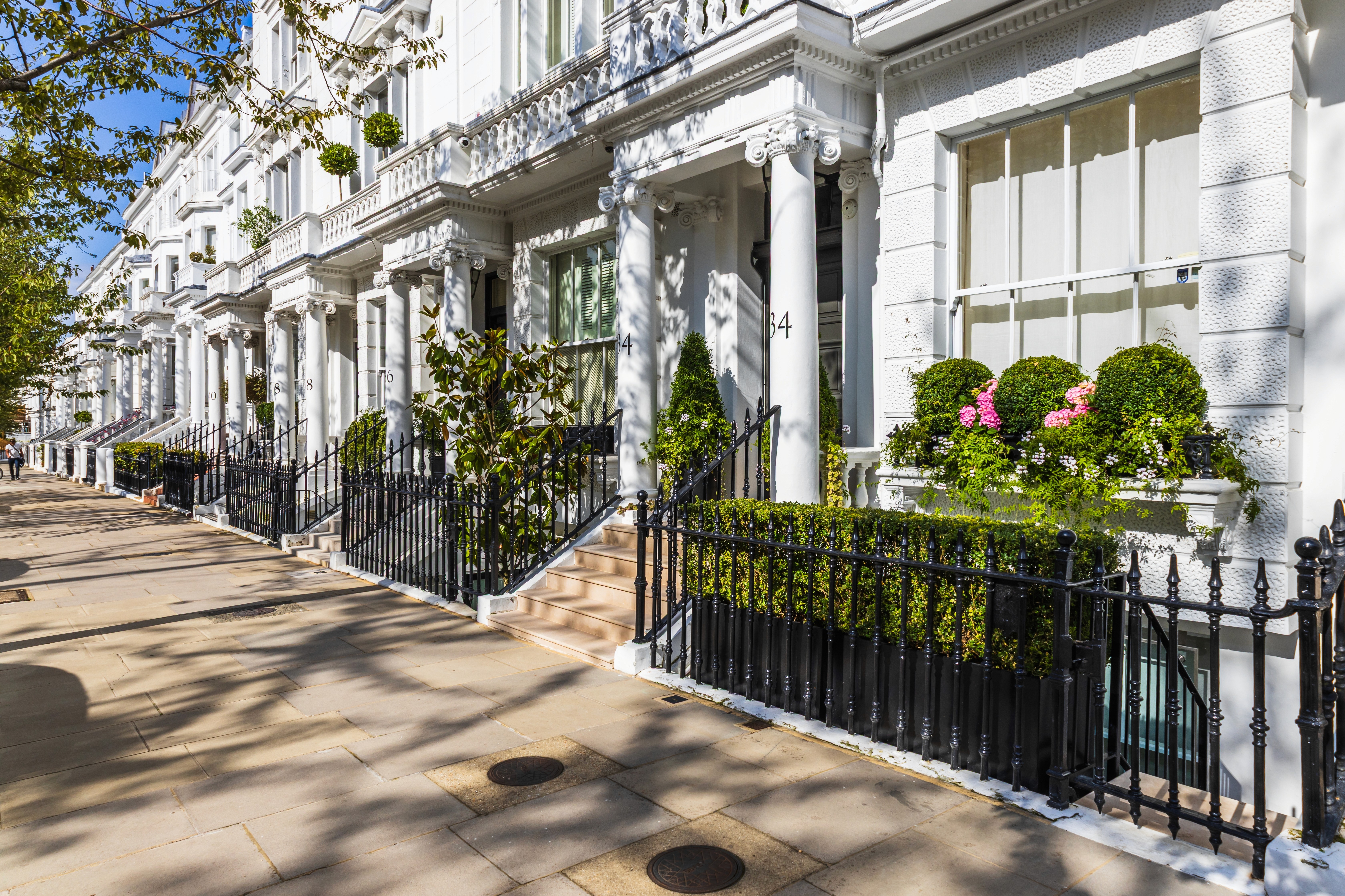 Elegant white townhouses in London, reflecting refined residential wealth within multi-jurisdictional structuring.