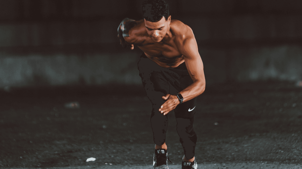 topless man in black pants and black shoes