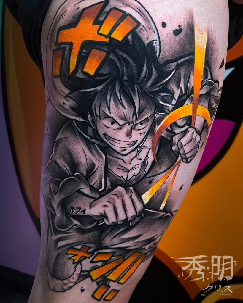 A striking tattoo of Luffy in black and grey, enhanced with a vivid pop of red for dramatic emphasis, showcasing his determined expression and signature straw hat.