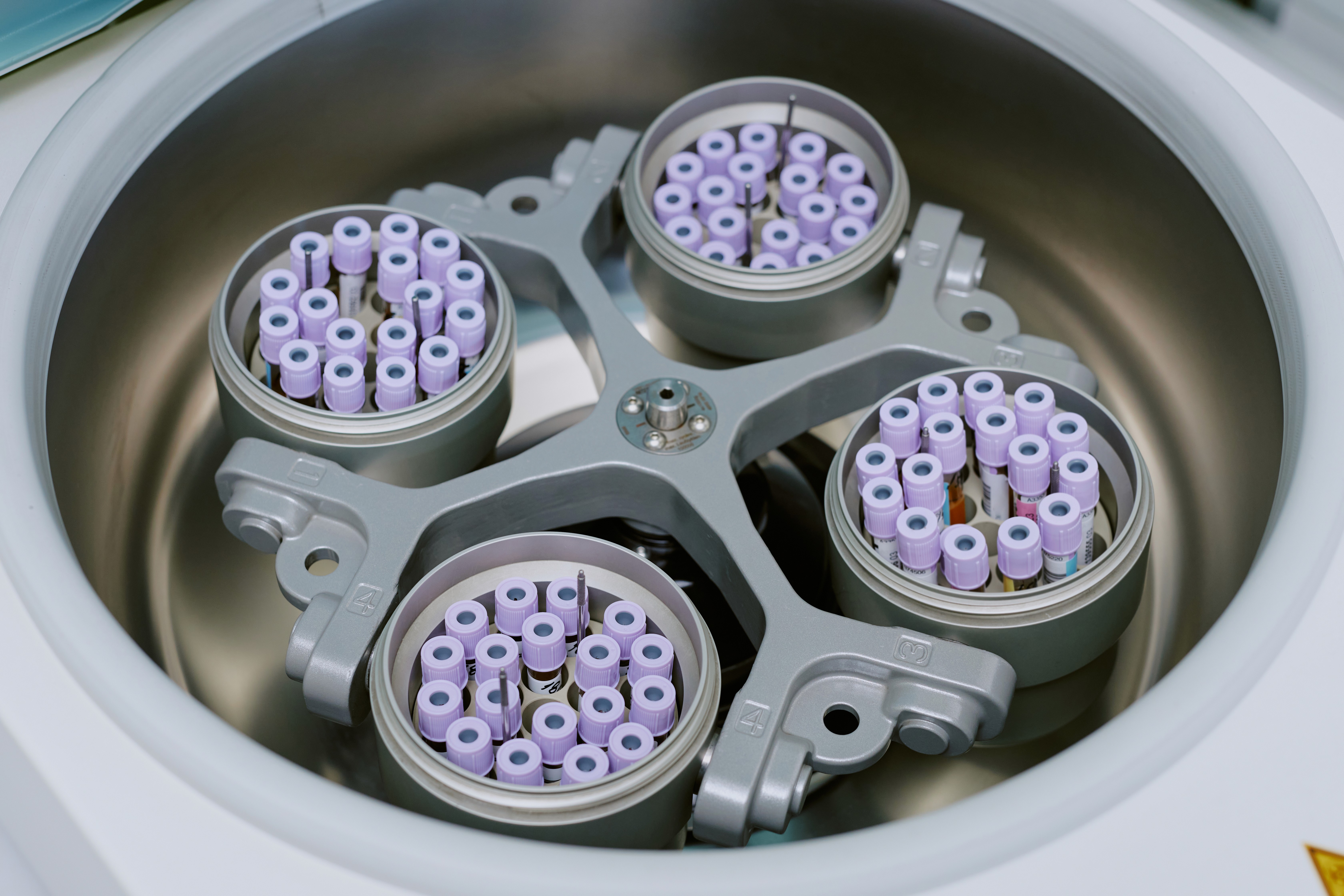 Modern office building with large windows reflecting a vivid orange sunset sky, silhouetted figure visible through the glass.