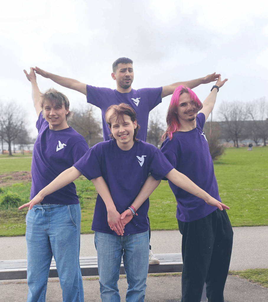 DDI team posing with arms outstretched to form a star shape