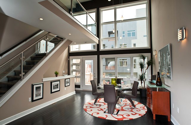 Living room showcasing the all glass back wall showing the city line.