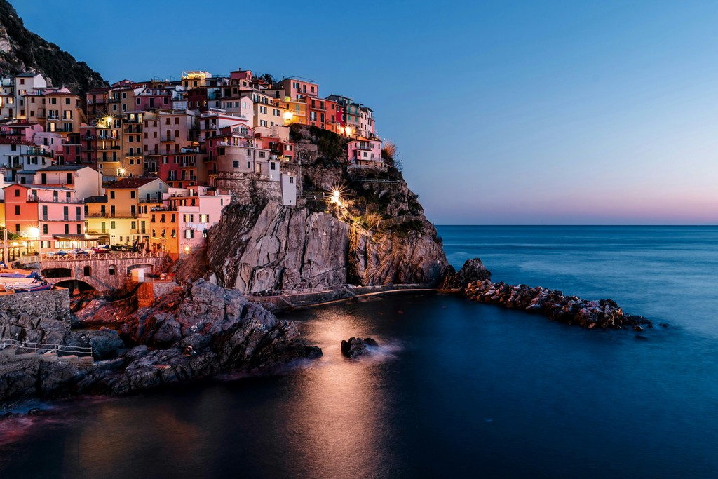 A city lit up at night near a body of water