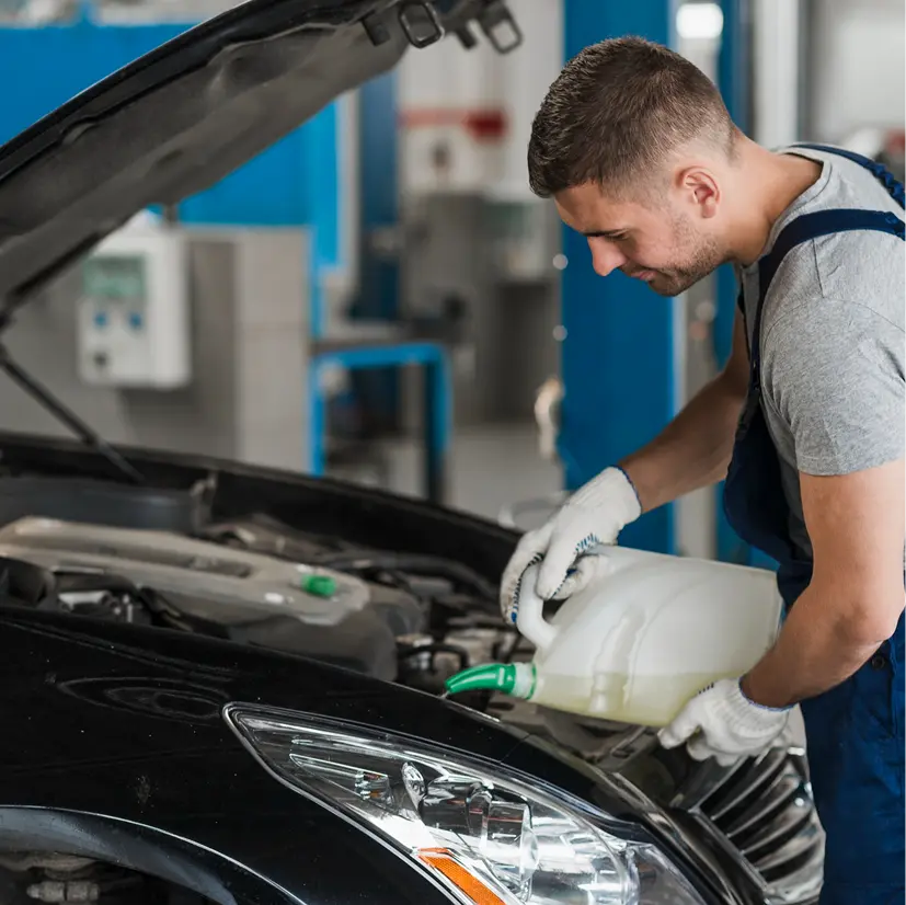 Mechanic pouring car fluid.