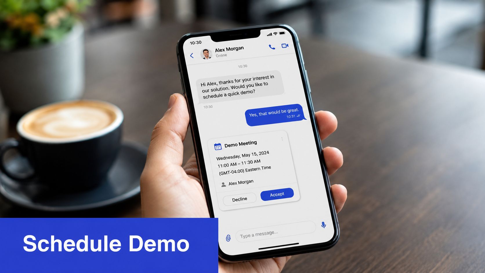 A hand holding a smartphone showing a business chat interface with a scheduled demo meeting request.