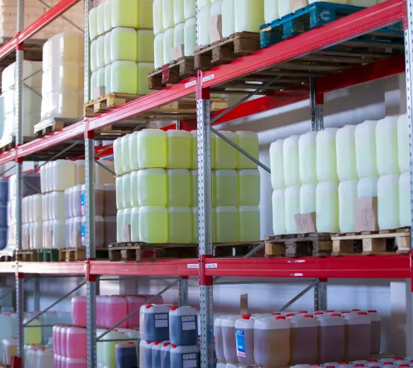 afety Data Sheet binder and labeled cleaning chemical containers in a commercial storage cabinet