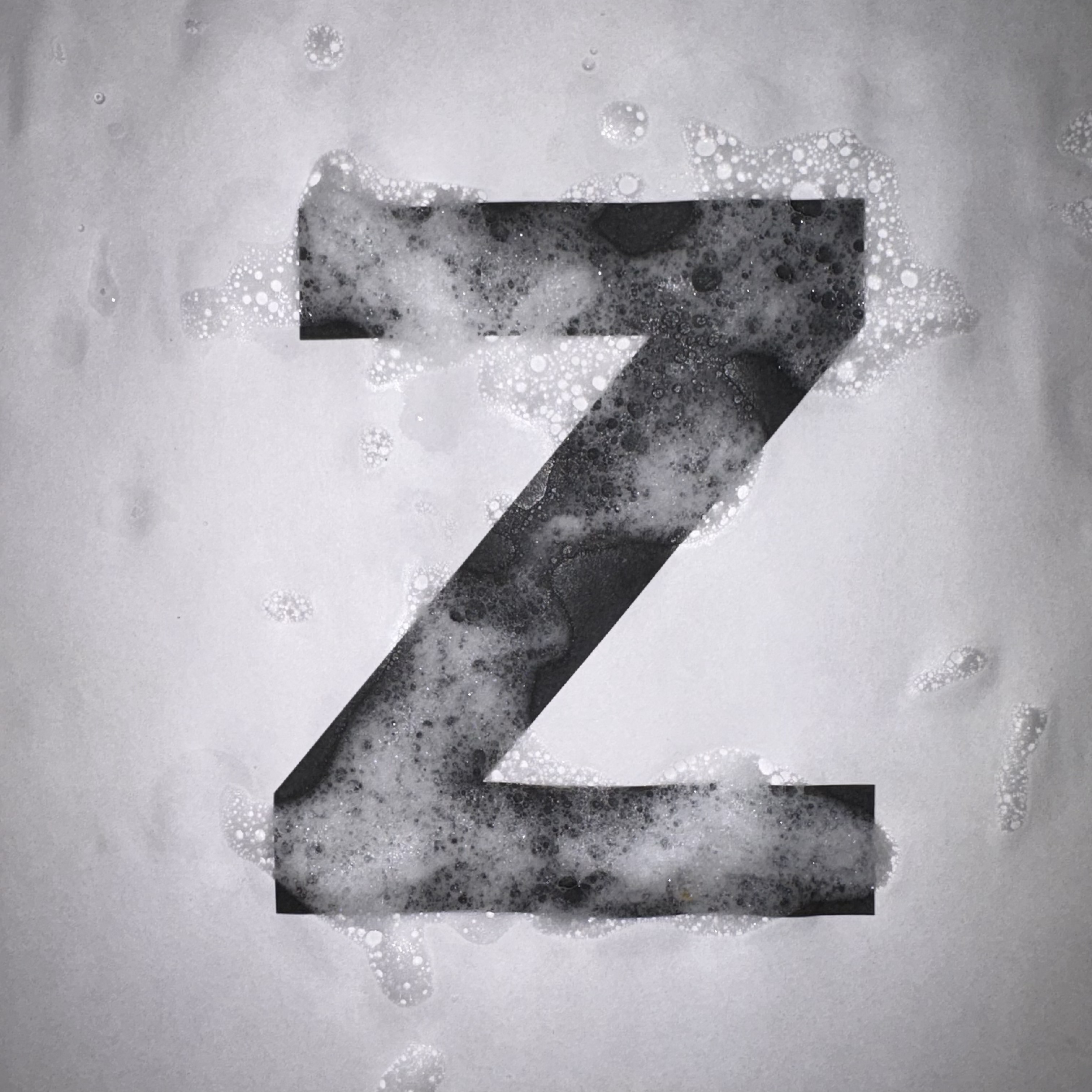 Soap foam photographed separately and overlaid in Photoshop — desaturate, maximize contrast, clip to letterform mask.