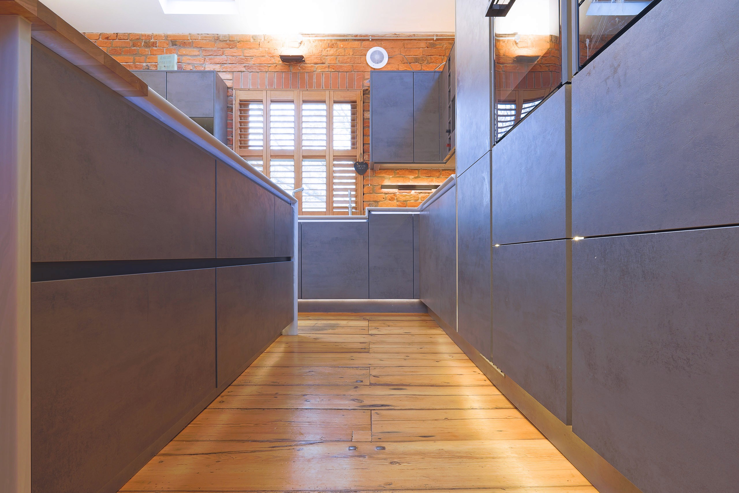 modern handleless concrete kitchen with corian worktops in wilmslow cheshire 
