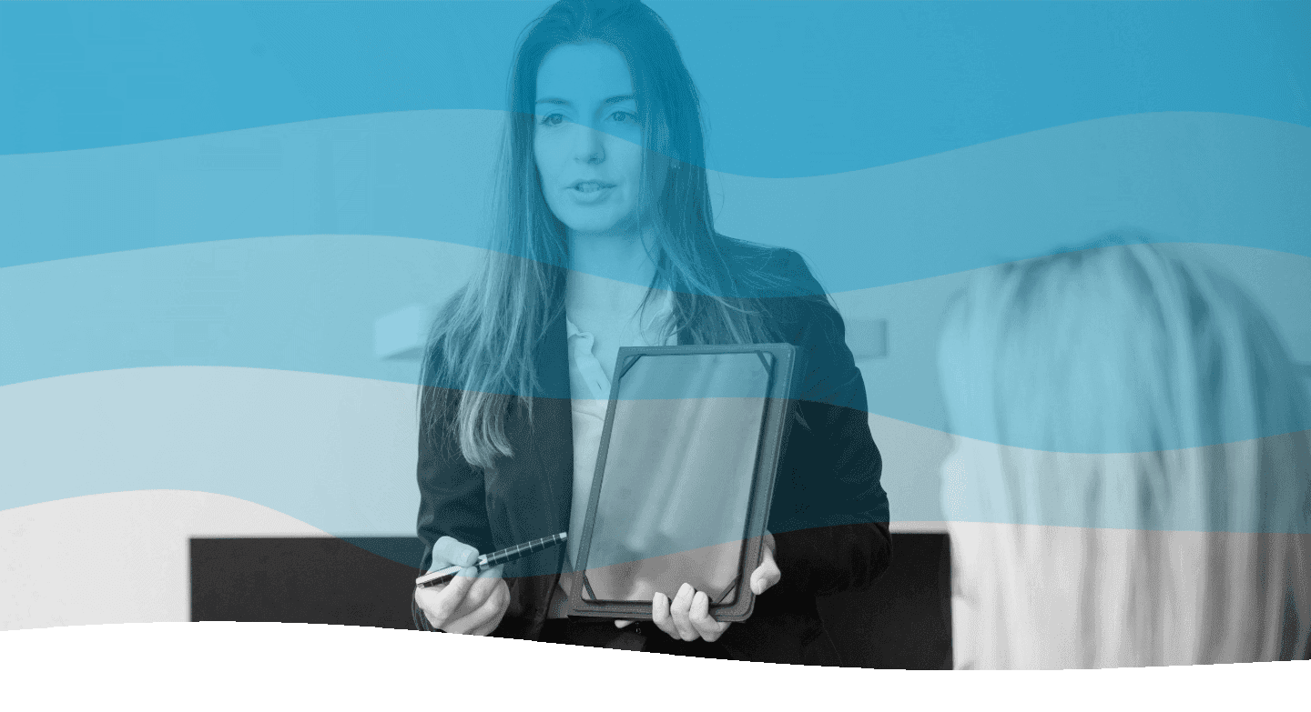 A woman in a business suit presents information on a tablet during a professional meeting, with a wave-shaped blue filter overlaying the image.