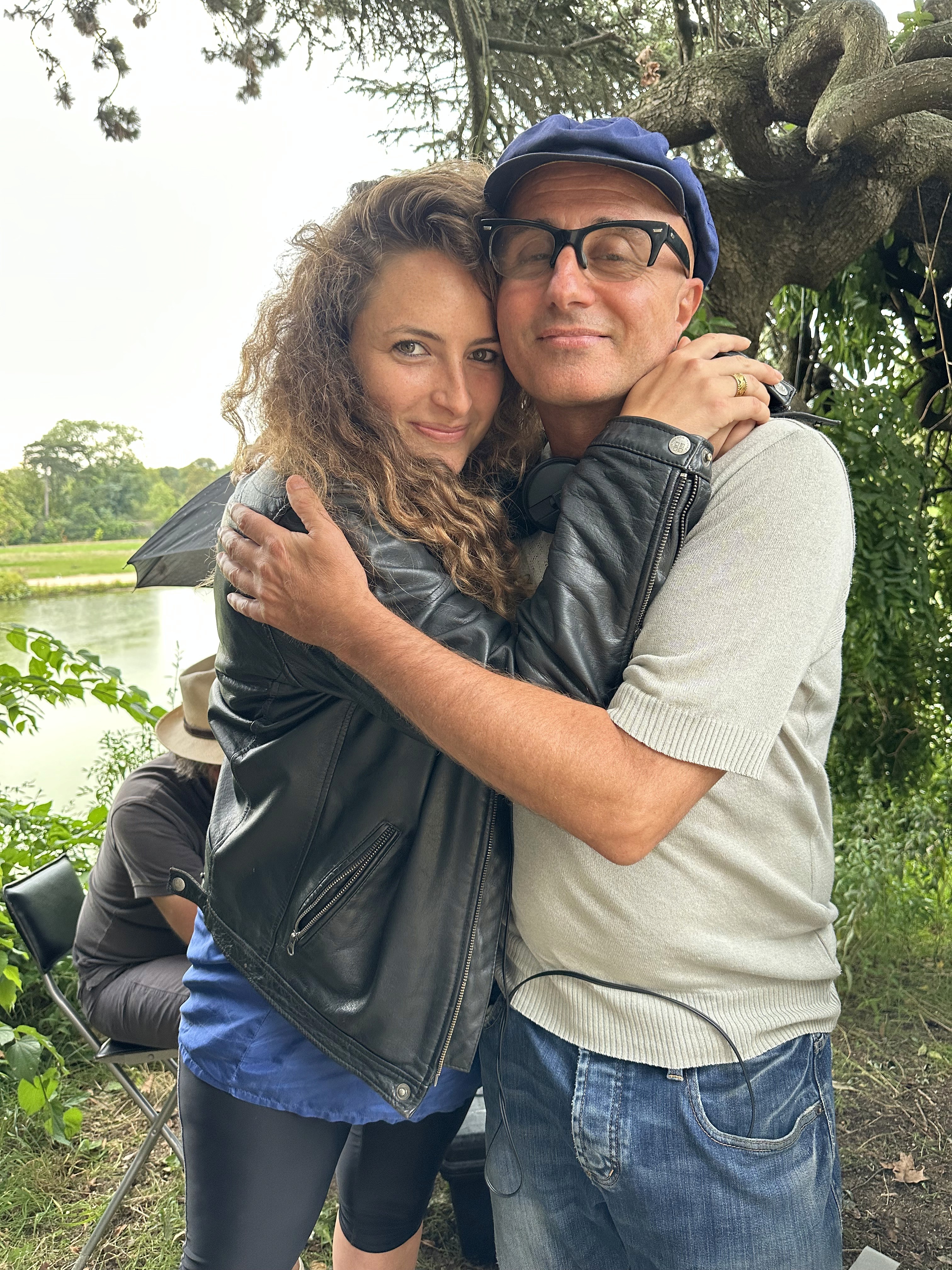 Woman in pink leather jacket crouching outdoors at night