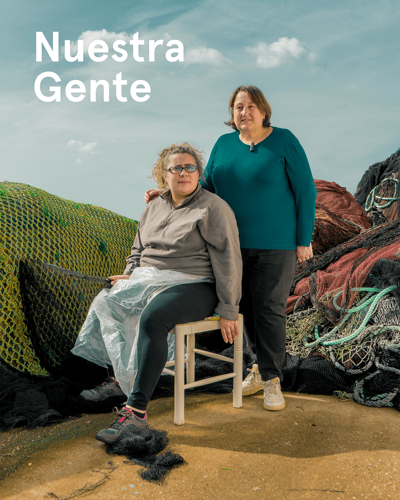 Two of Cangas' Netmenders surrounded by fishing nets