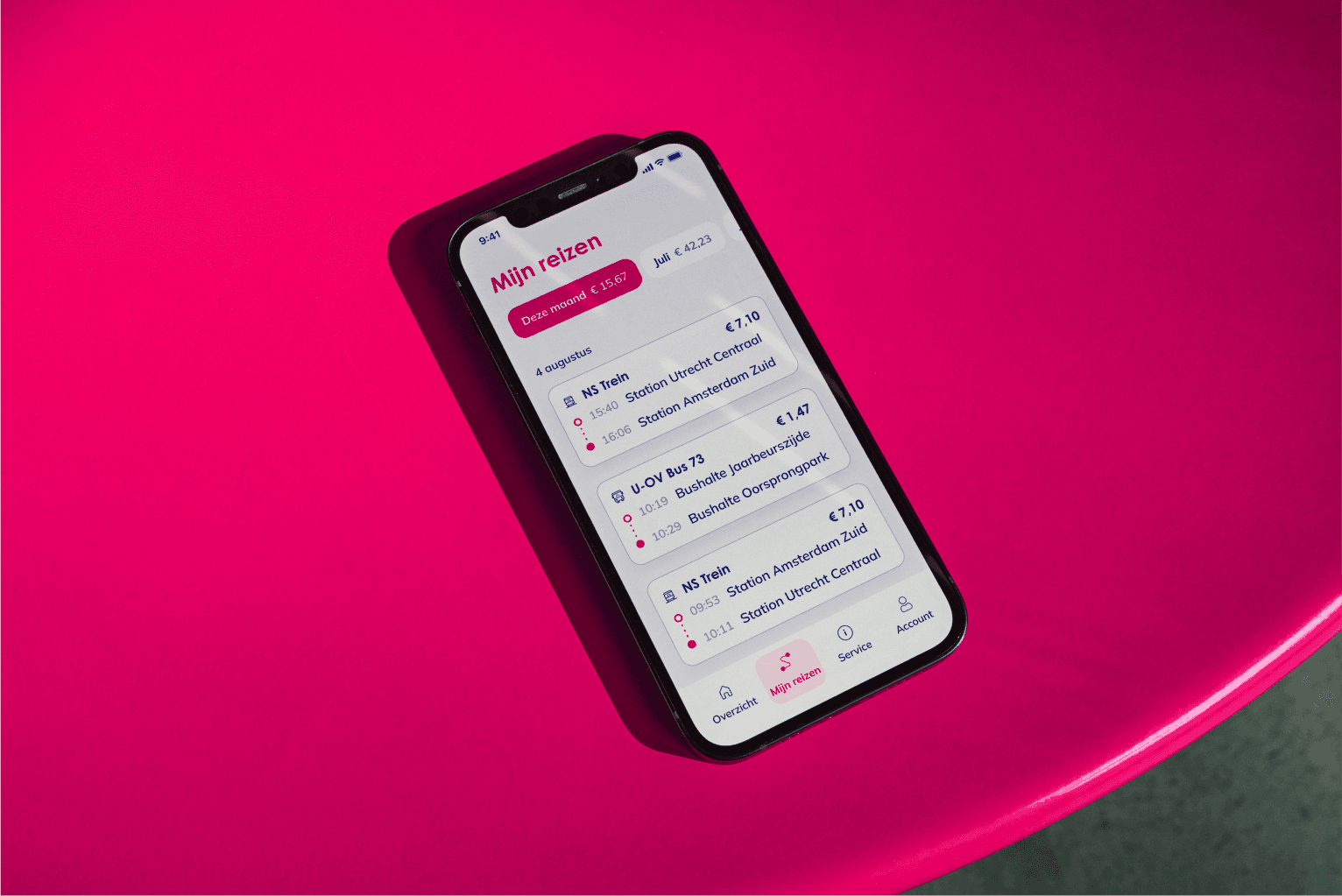 OVpay — smartphone resting on a bright pink surface with the OVpay travel history screen open — Soda Studio case study