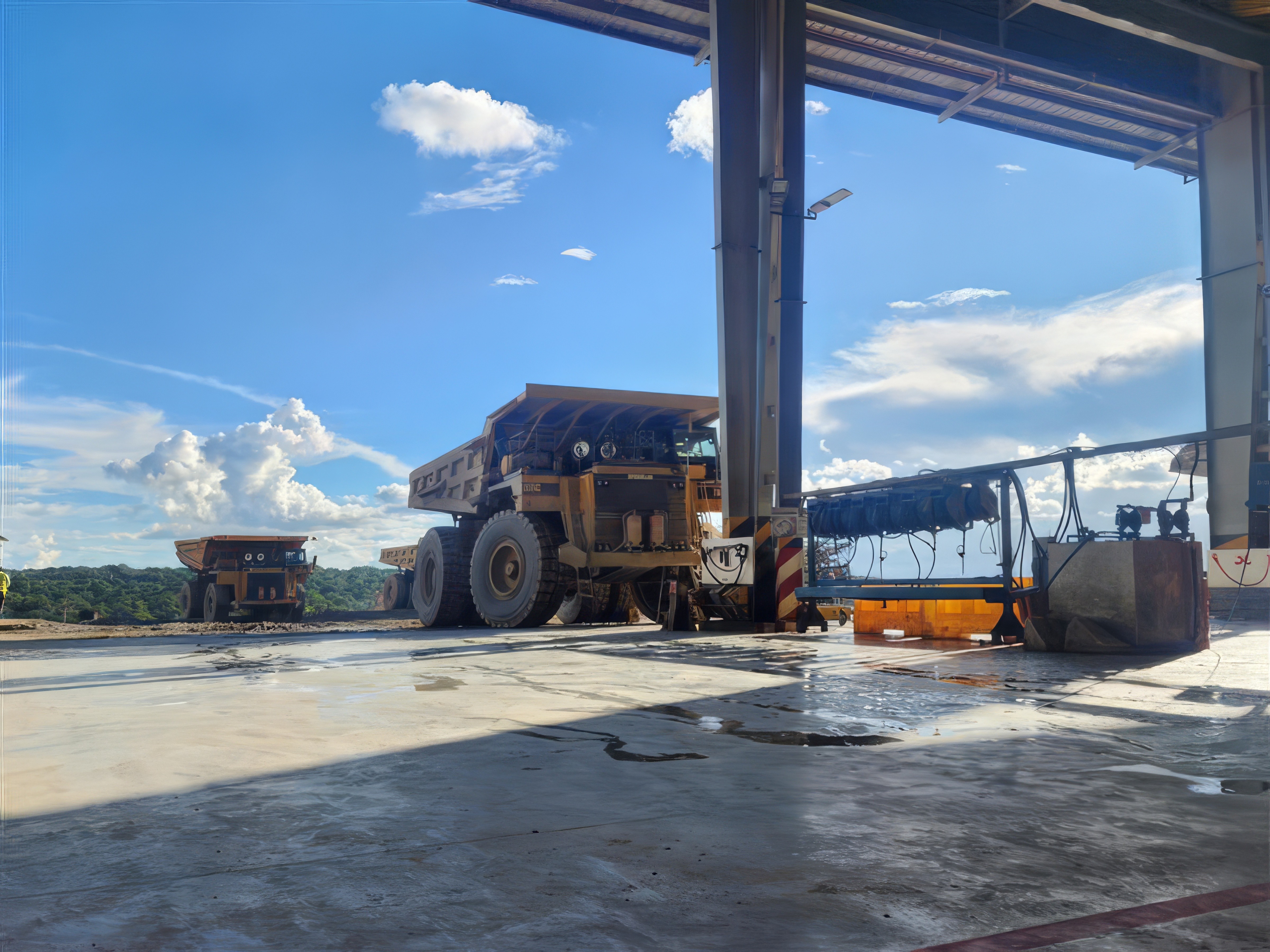 Close-up view of an orange shipping container suspended mid-air against a cloudy sky.