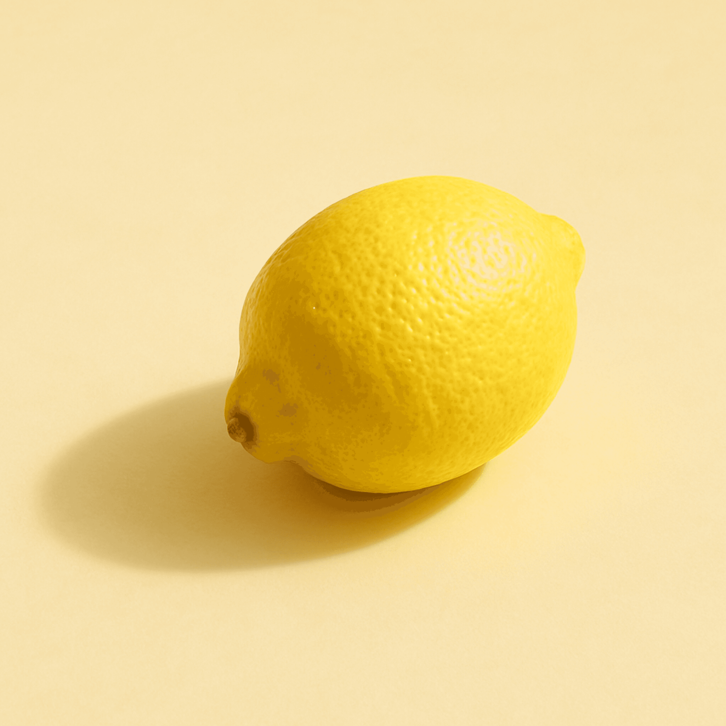 Single fresh lemon isolated on clean yellow backdrop