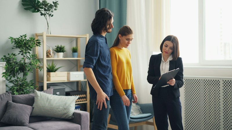 Agent showing a home to a couple