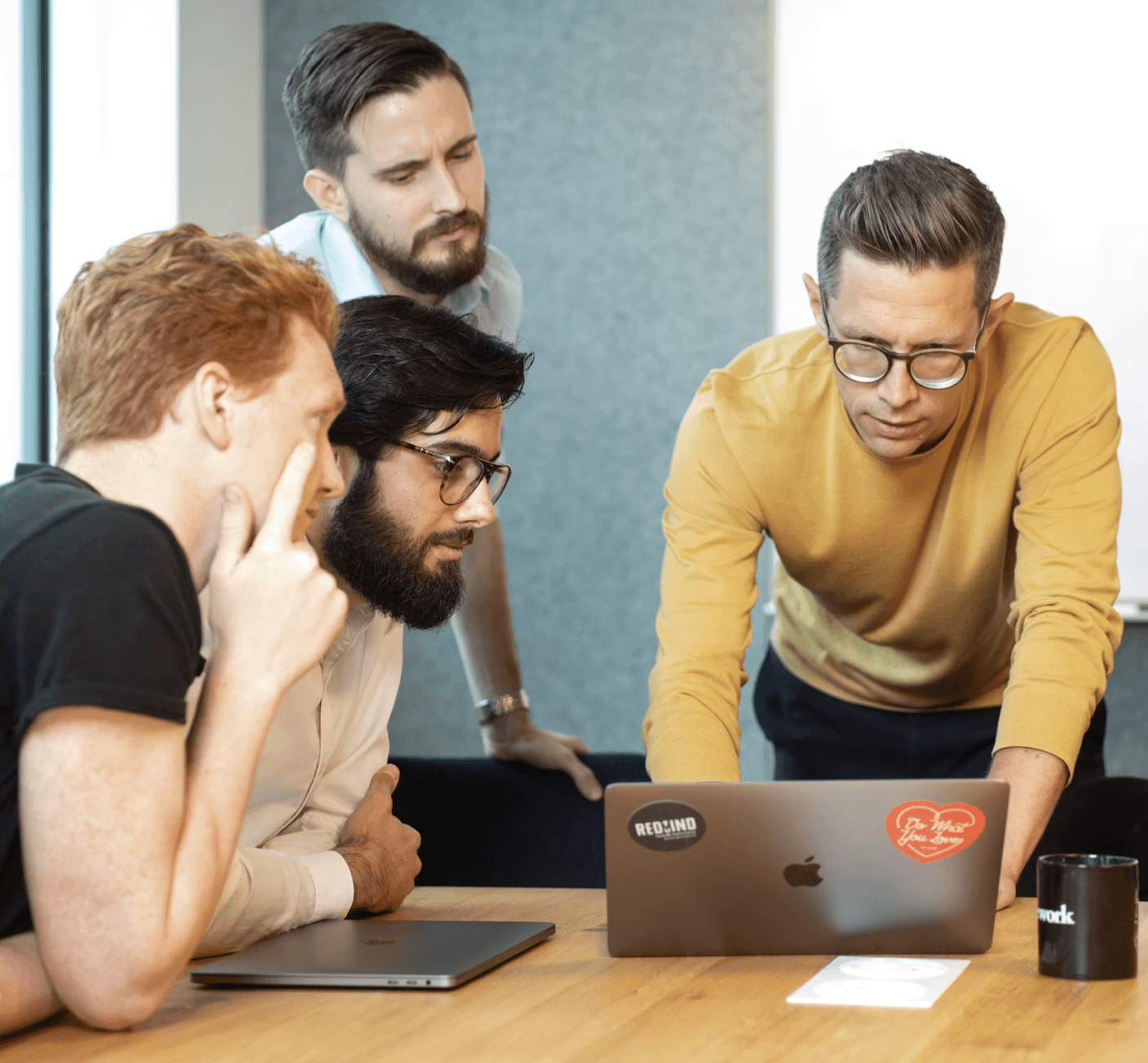 Team collaborating on laptop screen