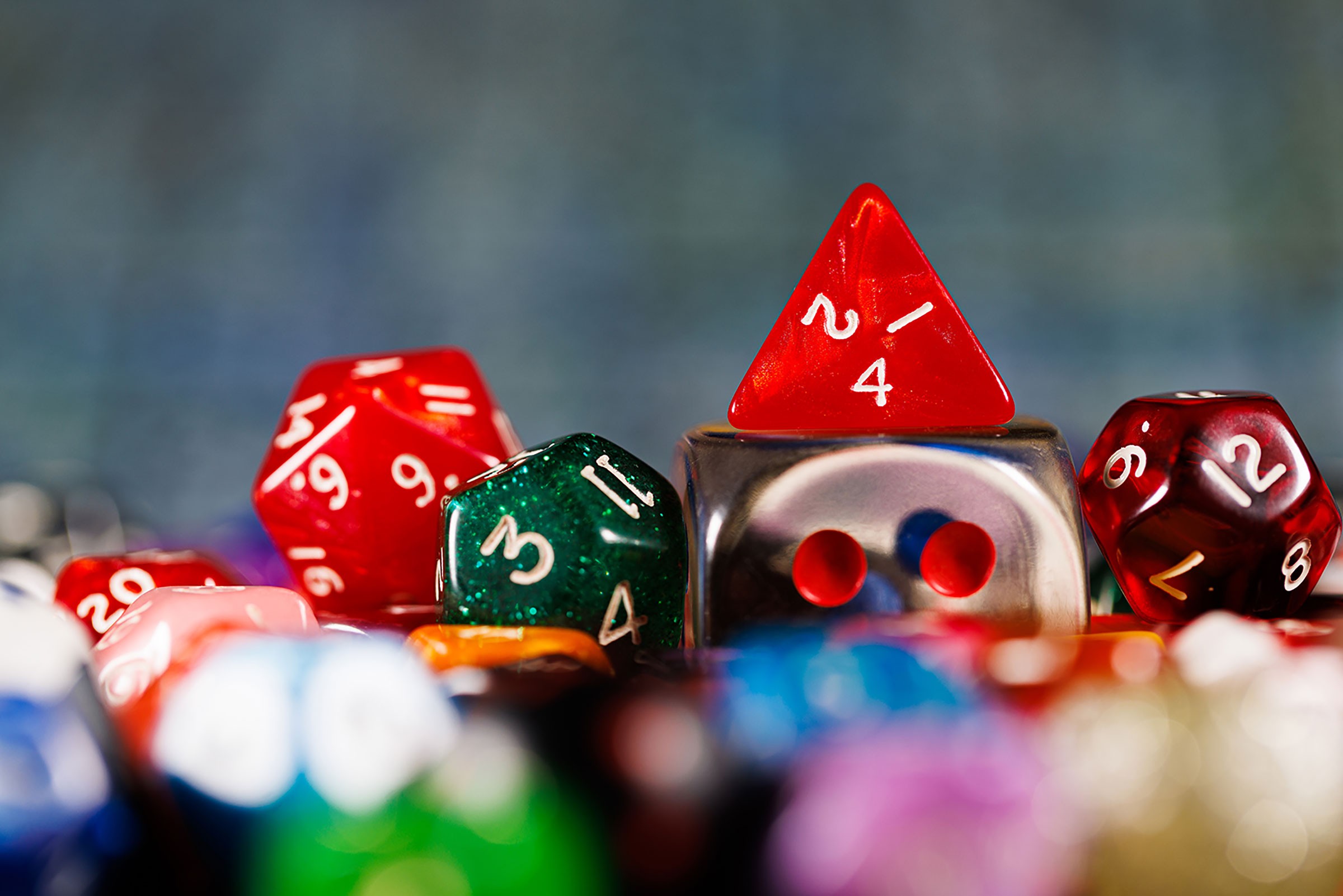 A close-up of a colourful collection of multi-sided gaming dice in various shapes and sizes.