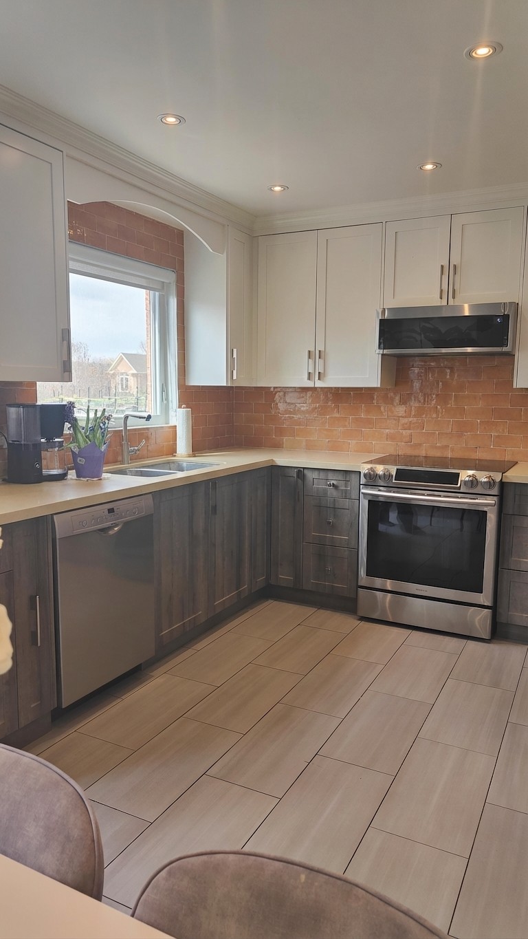 Same kitchen with terracotta zellige backsplash and warm cream counters