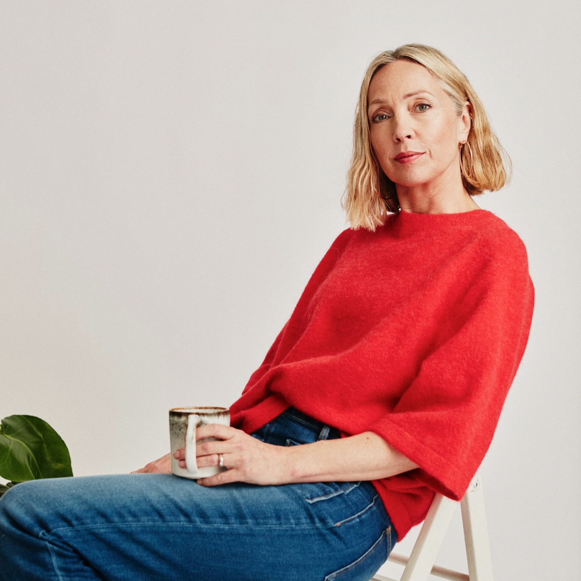 woman with red shirt seating on chair