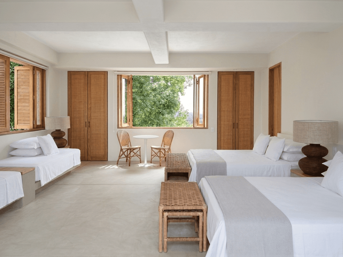 Modern countryside estate living room with a fireplace, broad seating area, and warm neutral finishes