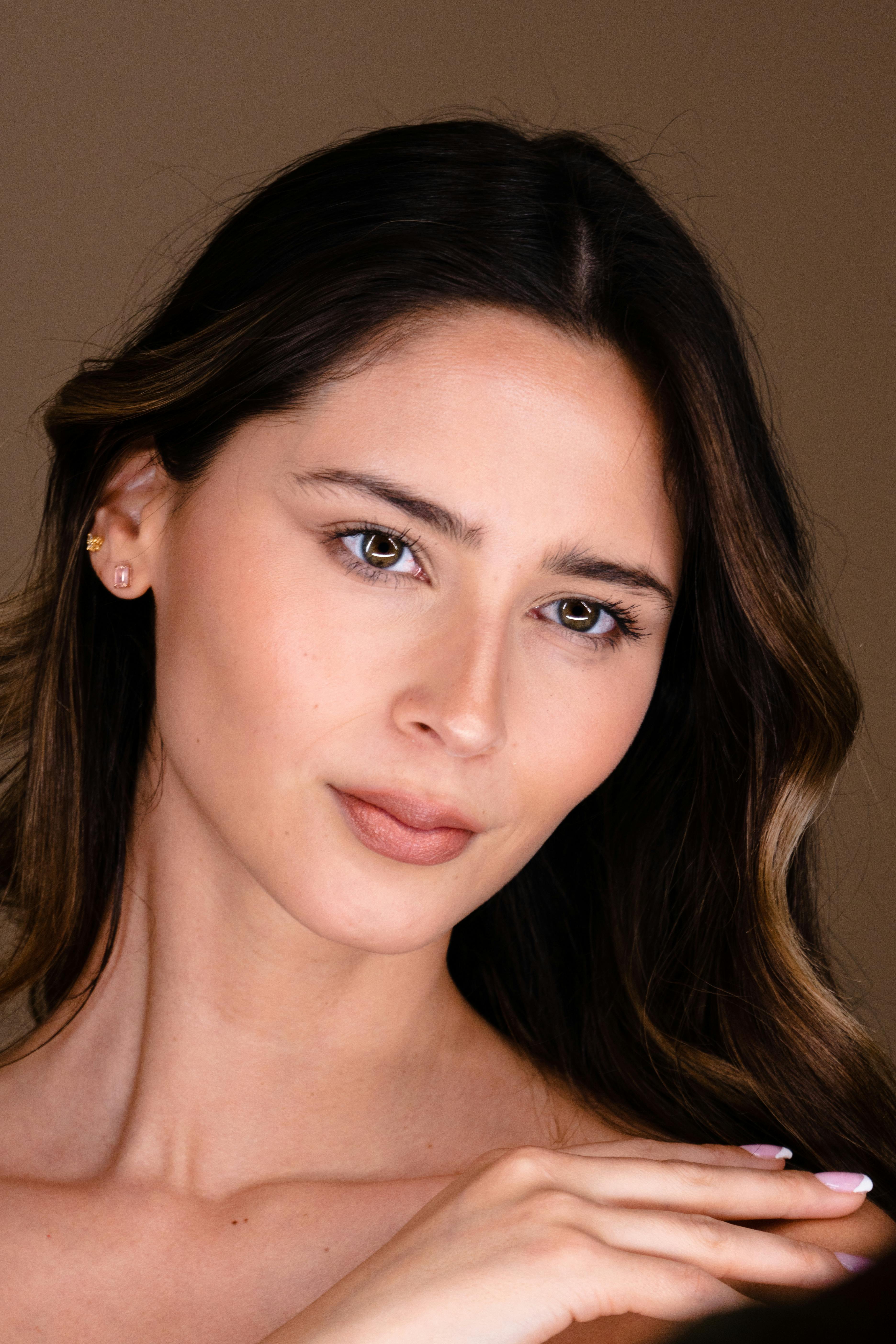 Natural beauty portrait of woman on warm neutral background for aesthetic clinic website