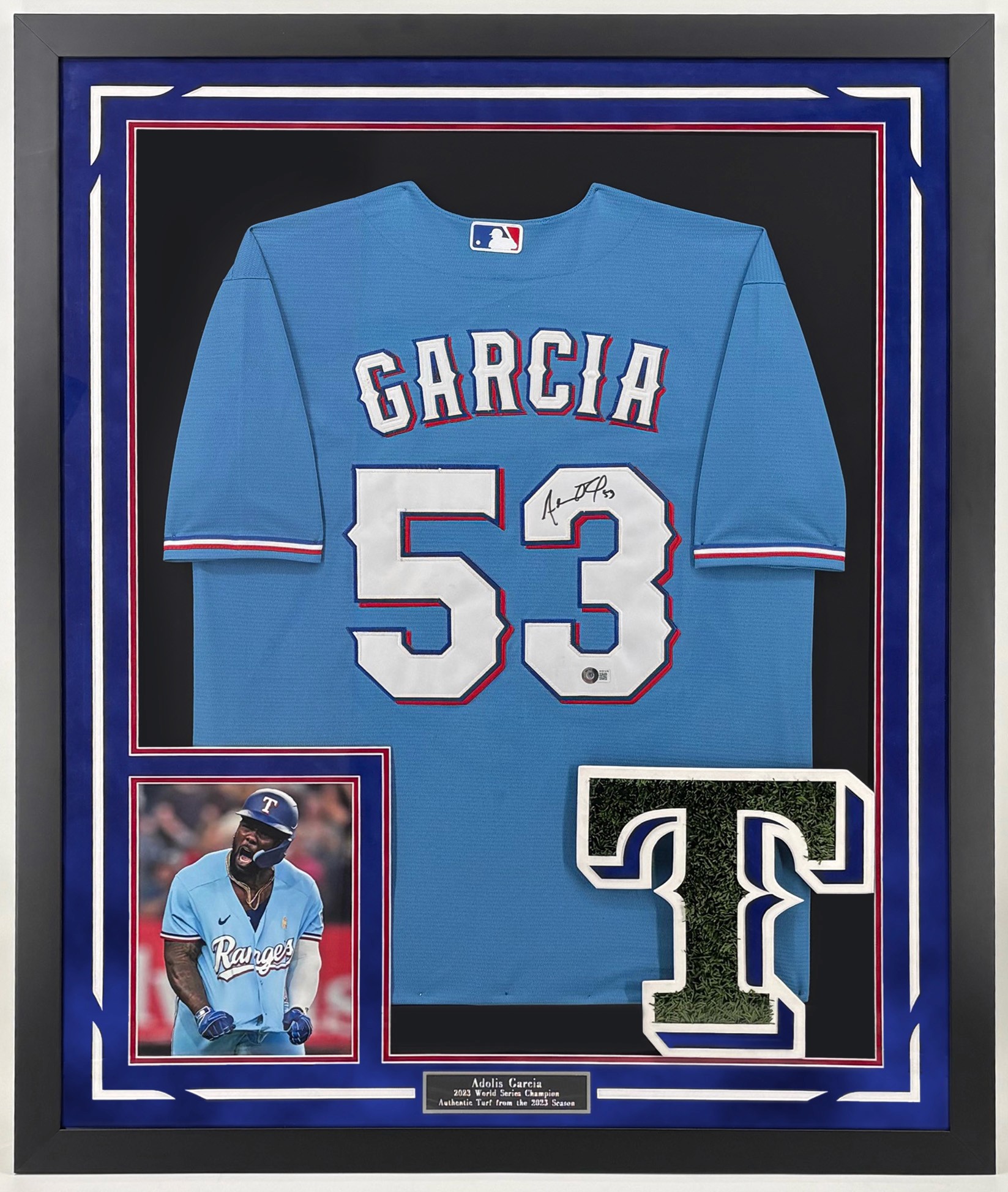 A serene outdoor seating area with two chairs, surrounded by lush greenery and a glassed-in structure.