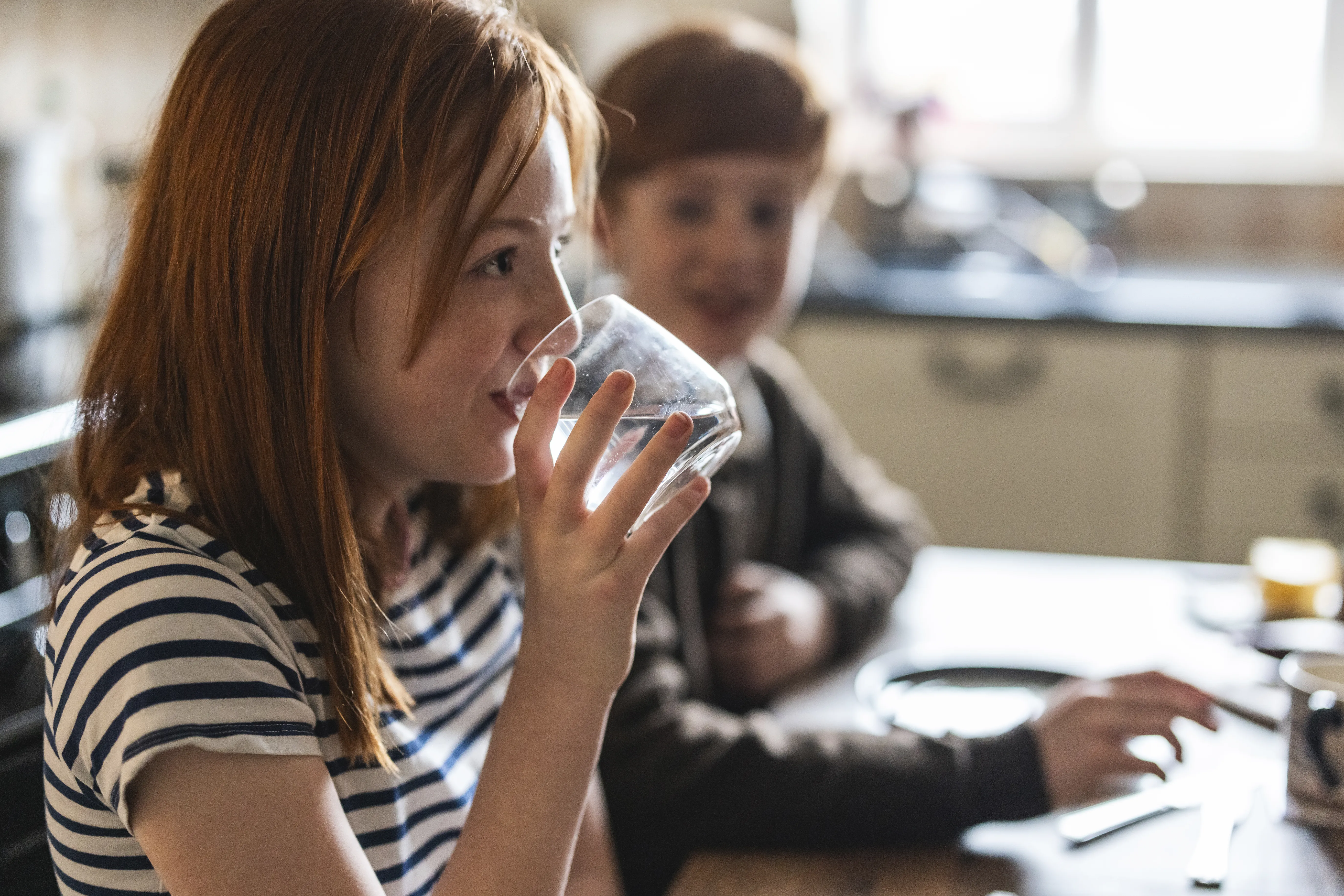 Little girl drinking glass of water
